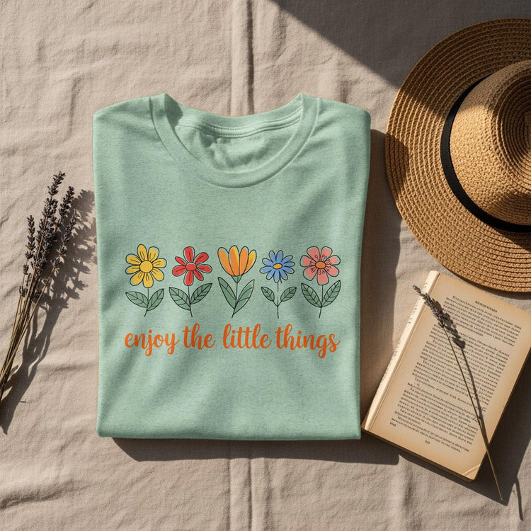 Mint green t-shirt with colorful flowers and the text "enjoy the little things".