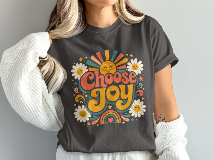 Dark grey t-shirt with "Choose Joy" text, radiating sun, daisies, and rainbow.