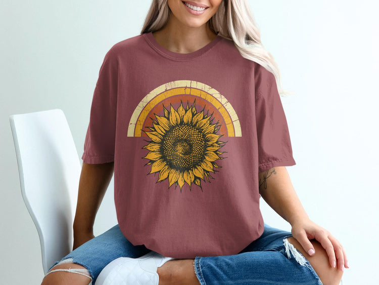 Maroon t-shirt with a vintage sunflower and rainbow graphic on the chest