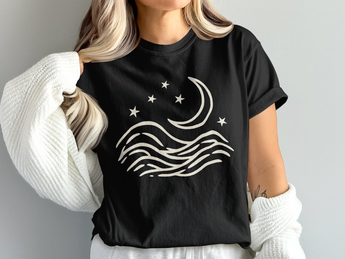Black t-shirt with cream crescent moon, stars, and wavy lines design.