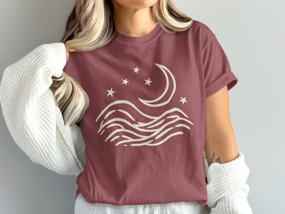 T-shirt with cream moon, stars, and wave graphic.