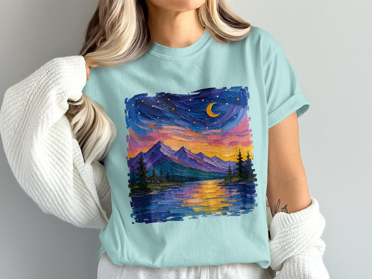 Light blue t-shirt with a colorful impressionist painting of a moonlit mountain lake landscape.