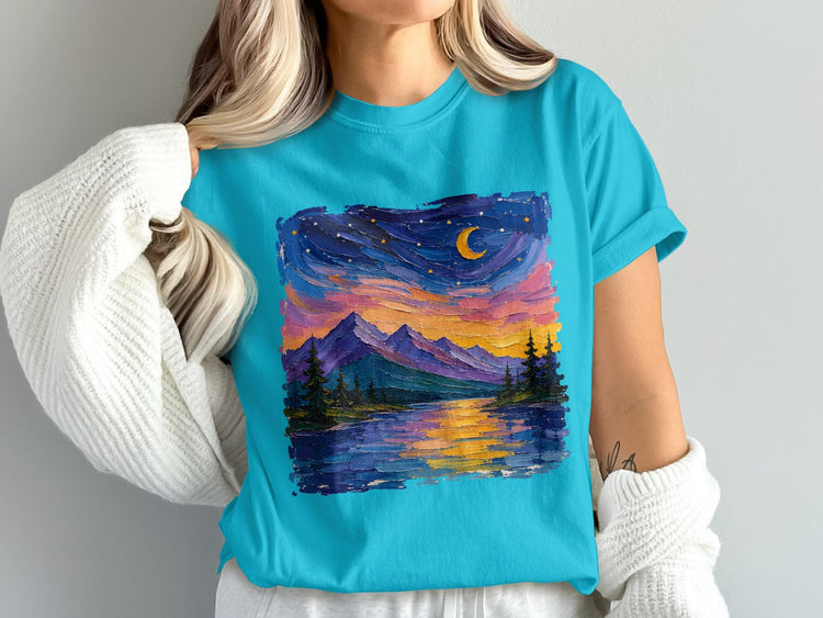 Turquoise t-shirt with oil-painted mountain lake landscape under a starry, crescent moon sky.