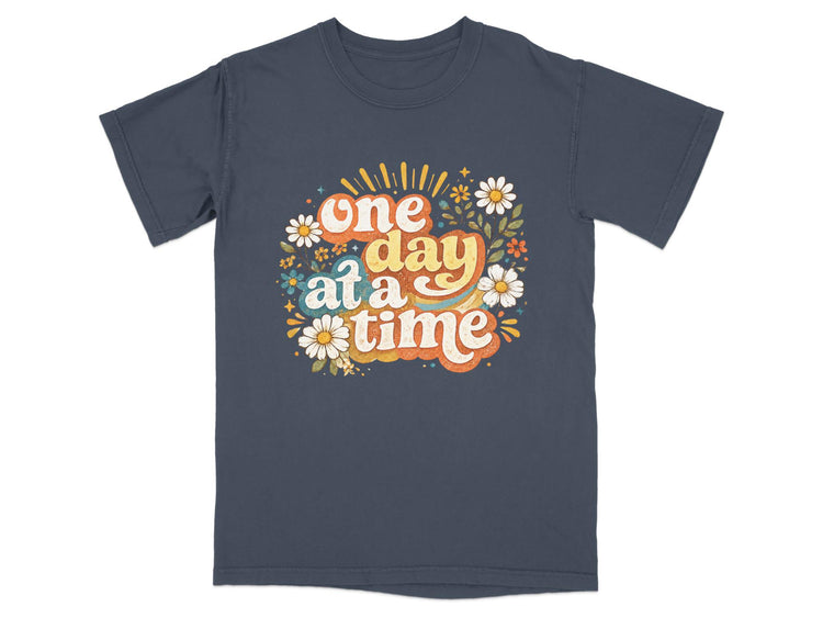 Dark gray t-shirt with "one day at a time" quote and floral design.