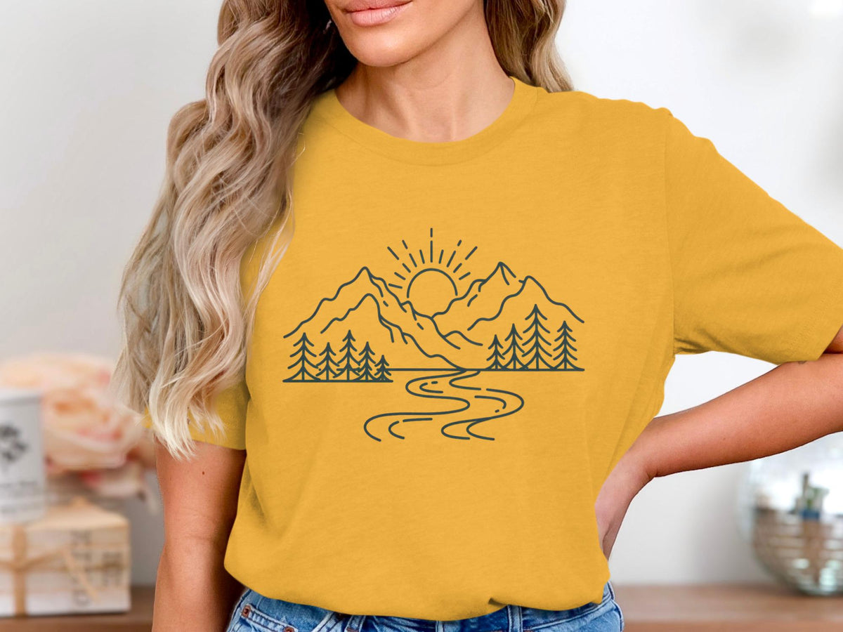Yellow t-shirt with a line art drawing of mountains, trees, and a winding river.