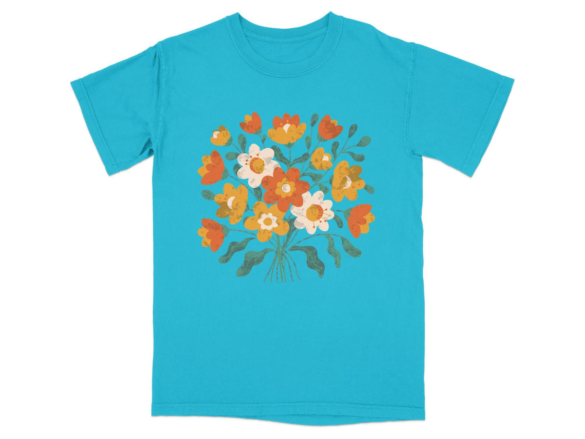 Teal t-shirt with a bouquet of orange, yellow, and white flowers.