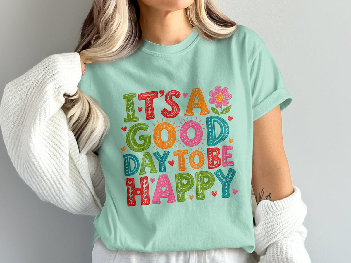 Mint t-shirt with "It's a good day to be happy" text and floral design.