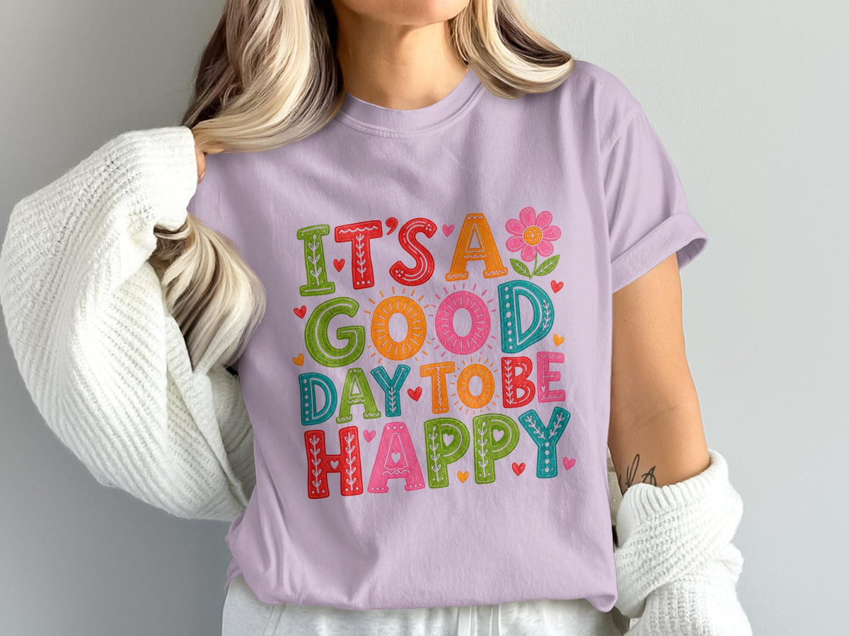 T-shirt with "It's a good day to be happy" in colorful lettering and floral accents.