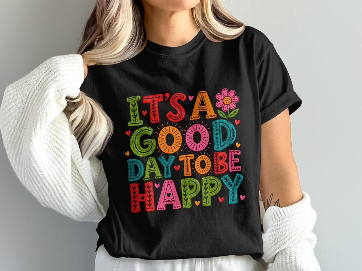 Black t-shirt with text "IT'S A GOOD DAY TO BE HAPPY" in colorful, distressed letters.