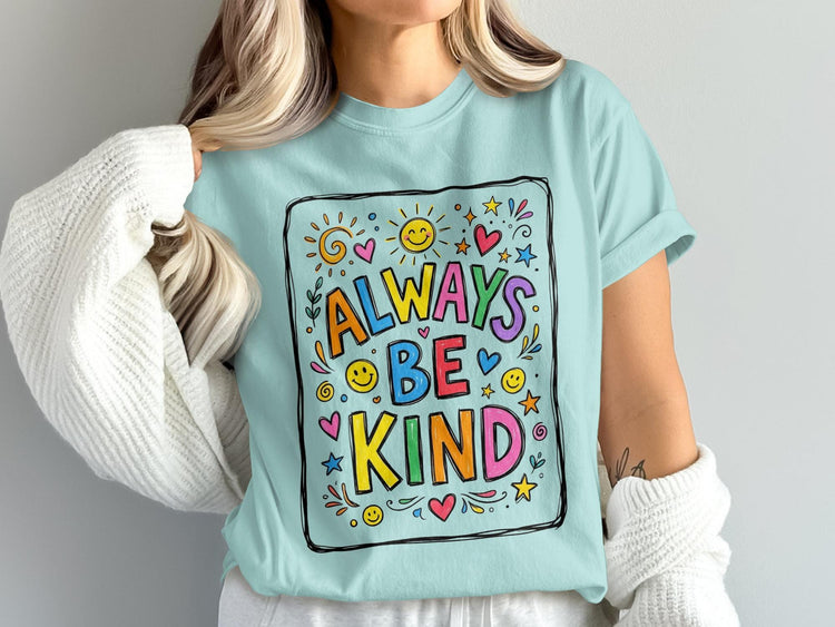 Light blue t-shirt with "Always Be Kind" text and colorful doodle art.