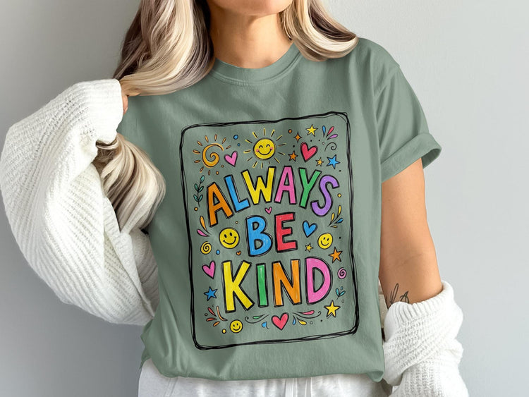 Green t-shirt with "Always Be Kind" text and colorful doodle art.