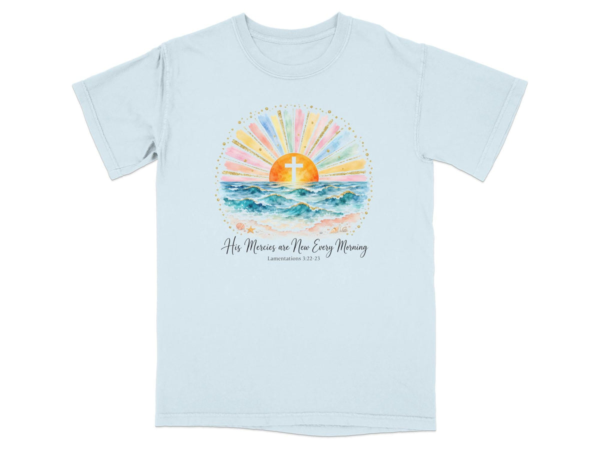 Light blue t-shirt with watercolor art of sunrise over ocean and text "His Mercies are New Every Morning".