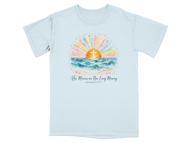 Light blue t-shirt with watercolor art of sunrise over ocean and text "His Mercies are New Every Morning".