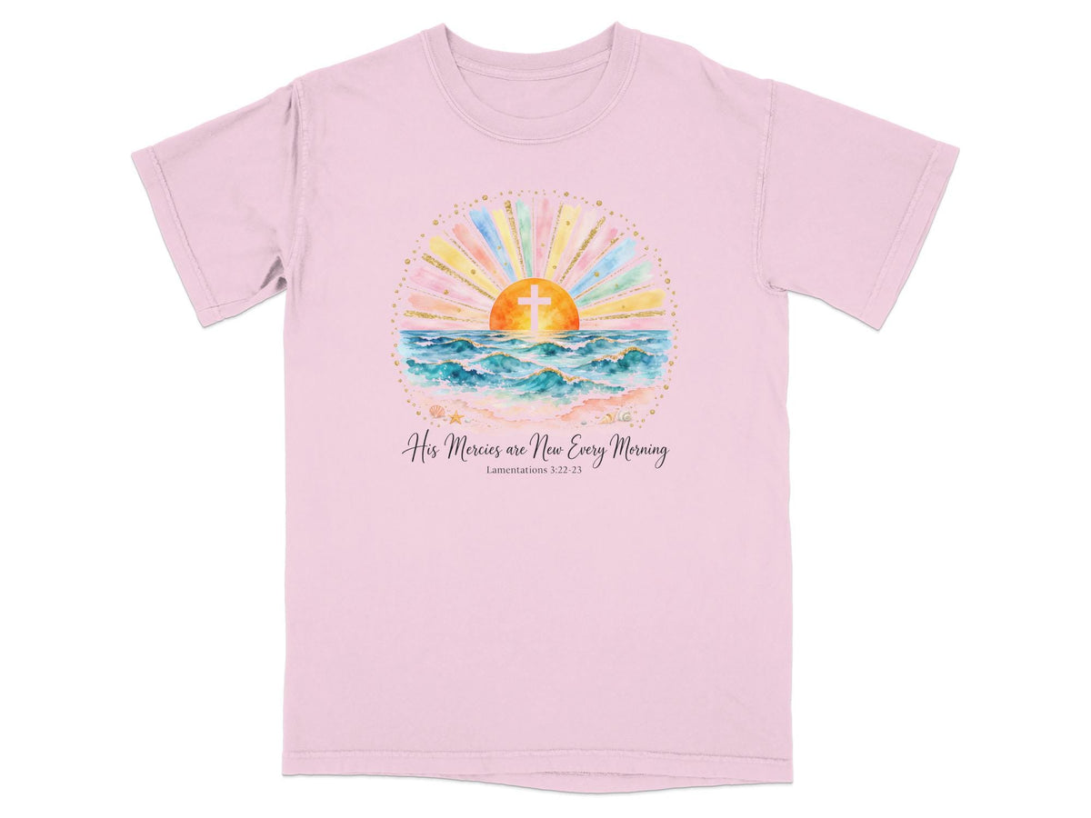 Pink t-shirt with watercolor sunrise over ocean, cross, and text "Lamentations 3:22-23".
