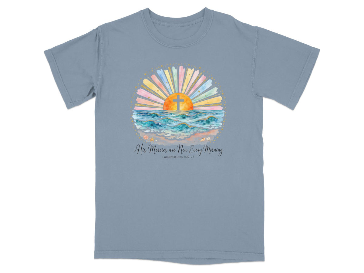 T-shirt with watercolor sunrise, cross, ocean waves, and biblical text.