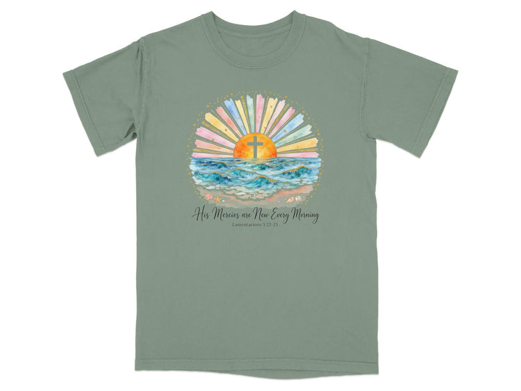 Green t-shirt with watercolor sunrise over ocean, cross graphic, and bible verse.