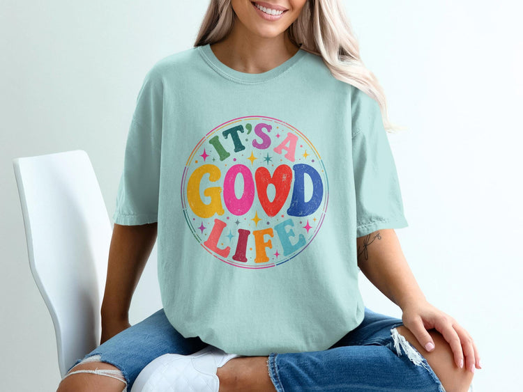 Light blue t-shirt with circular graphic reading "IT'S A GOOD LIFE".