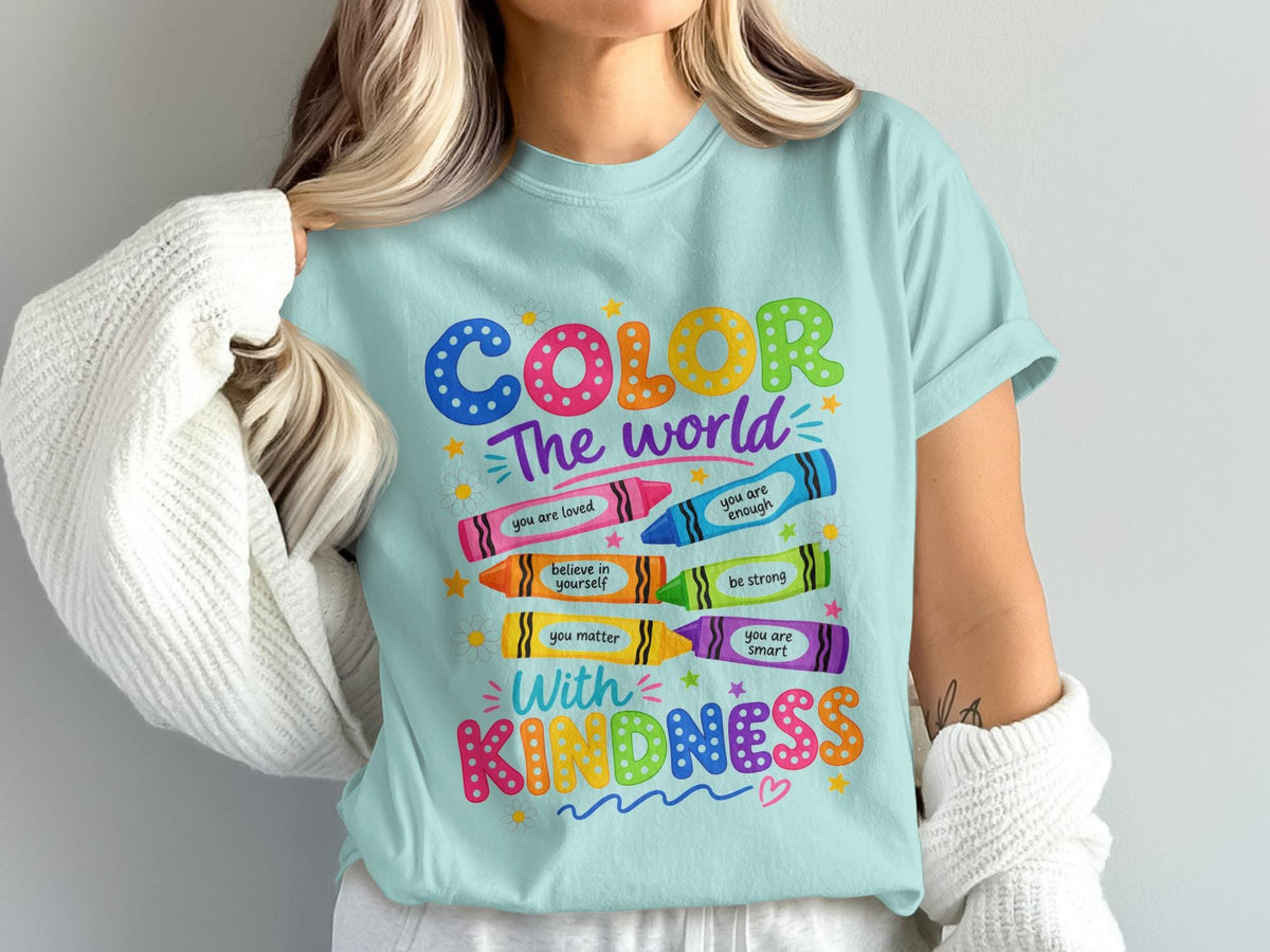 Light blue t-shirt with "COLOR The world With KINDNESS" and affirmations on crayons.