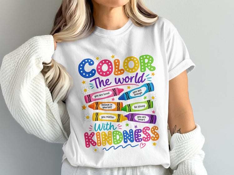 White t-shirt with "Color the World With KINDNESS" text and crayon graphics.