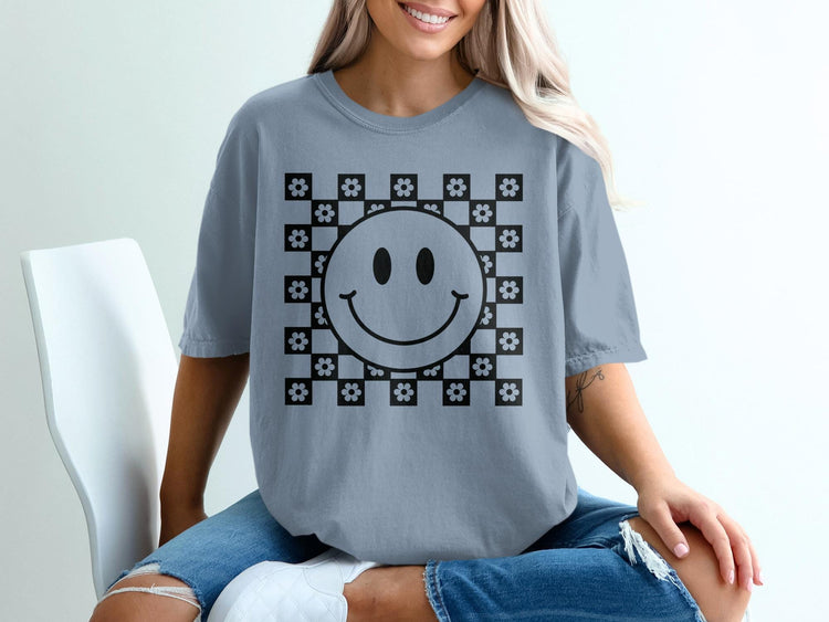 Gray t-shirt with black checkerboard flower and smiley face graphic.