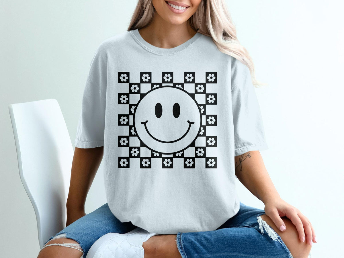Light grey t-shirt with a black and white checkerboard flower smiley face graphic.