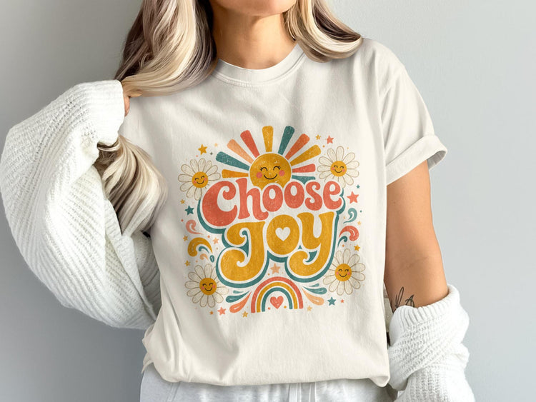 Cream t-shirt with retro graphic reading "Choose Joy" with sun and daisies.