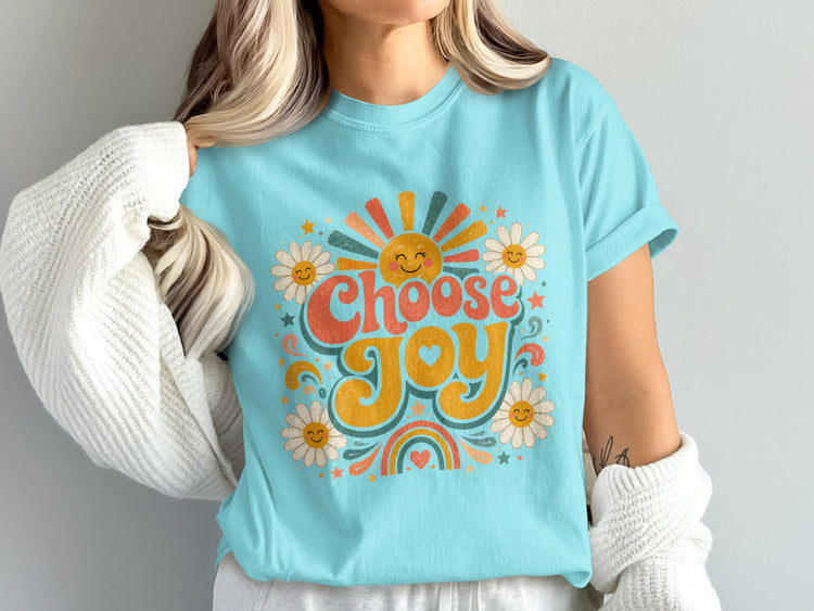 Light blue t-shirt with "Choose Joy" graphic featuring sun, daisies, and rainbow.