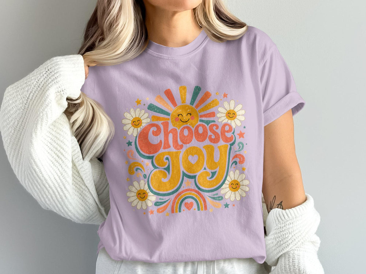 Lavender t-shirt with "Choose Joy" text and retro-style sun, daisies, and rainbow graphic.