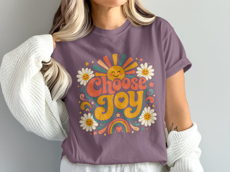 Purple t-shirt with retro "Choose Joy" graphic featuring sun, daisies, and rainbow.