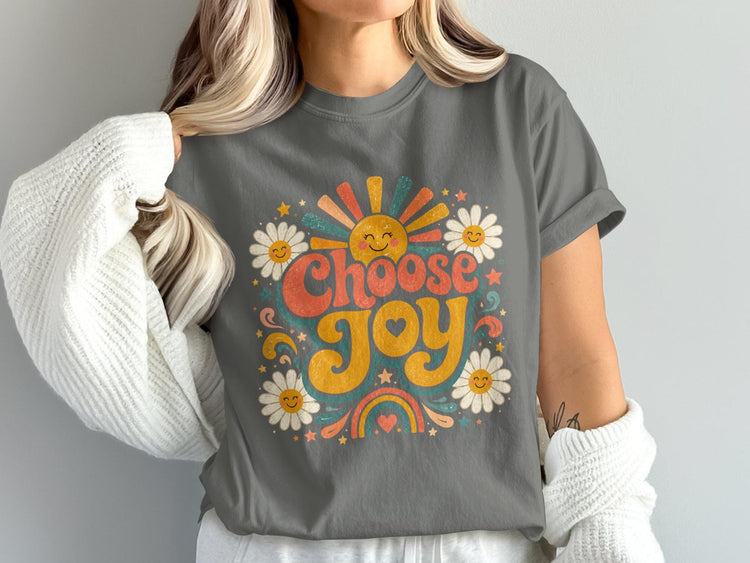 Graphic tee with "Choose Joy" text, smiling sun, daisies, and rainbow.
