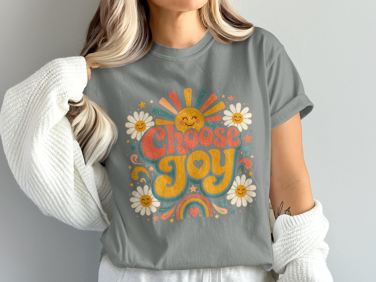 T-shirt graphic with "Choose Joy" text, sun, daisies, stars, and rainbow in retro style.