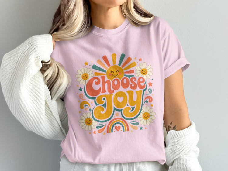 Pink t-shirt with "Choose Joy" graphic featuring a smiling sun and daisies.