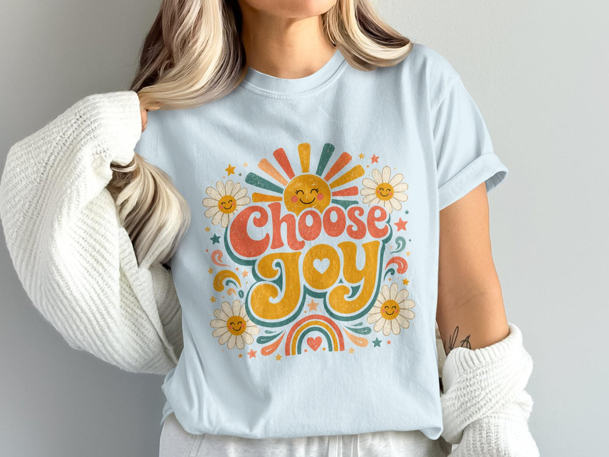 Light blue t-shirt with "Choose Joy" graphic featuring sun, daisies, rainbow, and stars.