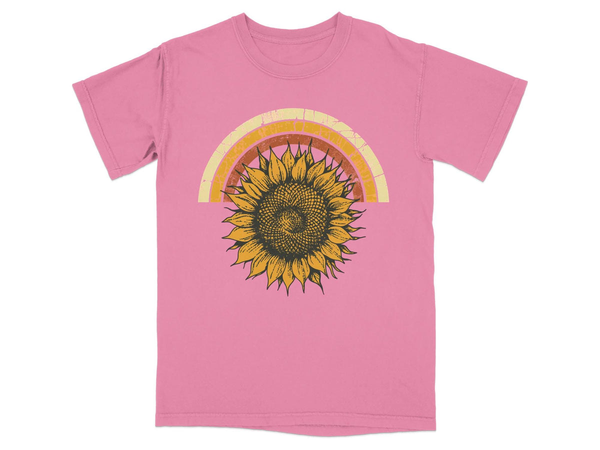Pink t-shirt with a retro sunflower and rainbow graphic print.