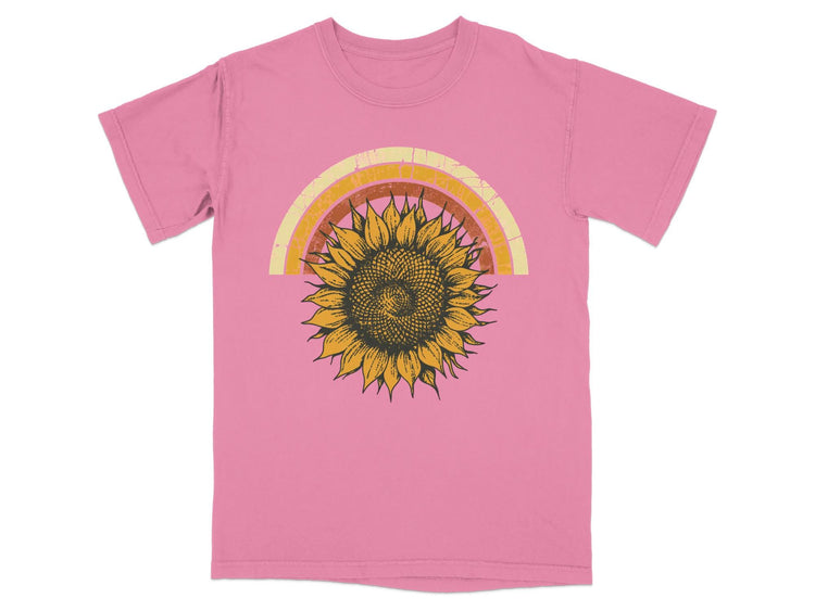 Pink t-shirt with a retro sunflower and rainbow graphic print.