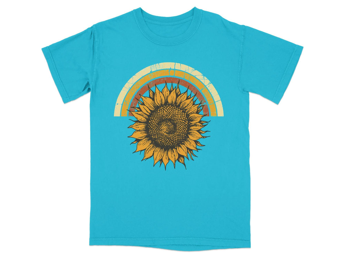 Turquoise t-shirt with distressed rainbow and sunflower graphic.