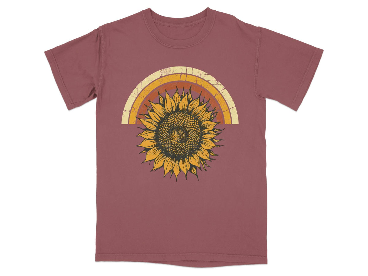 Maroon t-shirt with distressed rainbow arch and a sunflower graphic.
