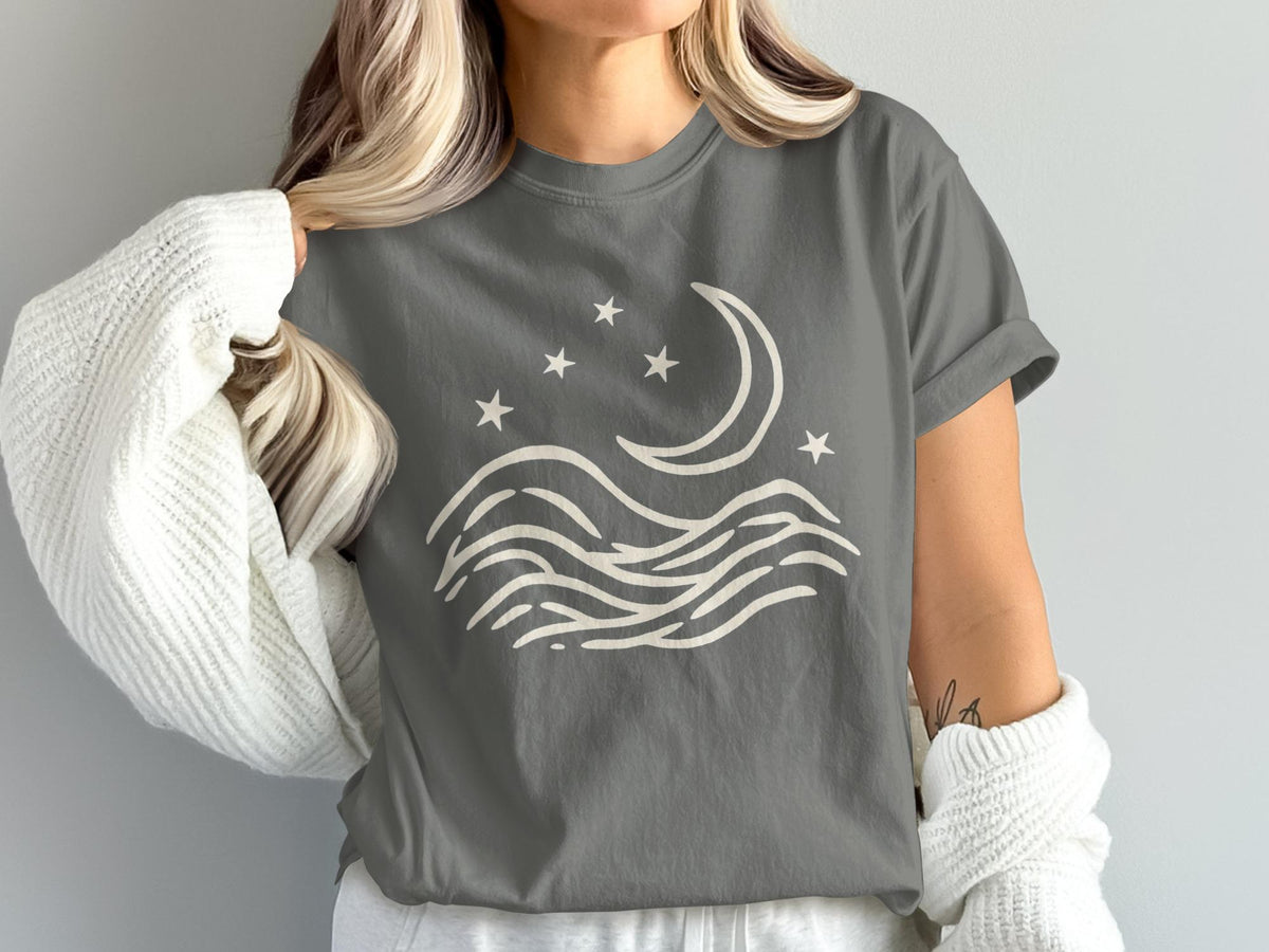 Gray t-shirt with a cream crescent moon, stars, and wavy lines graphic.
