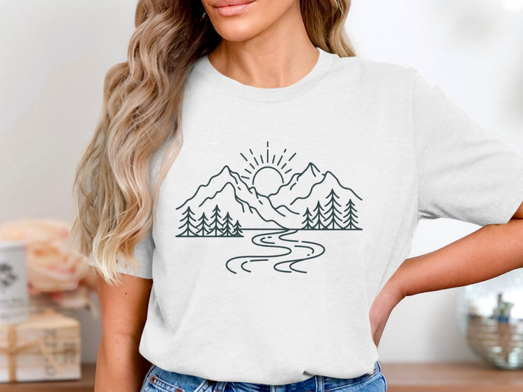 White t-shirt with a minimalist line art graphic of mountains, sun, trees, and a winding river.