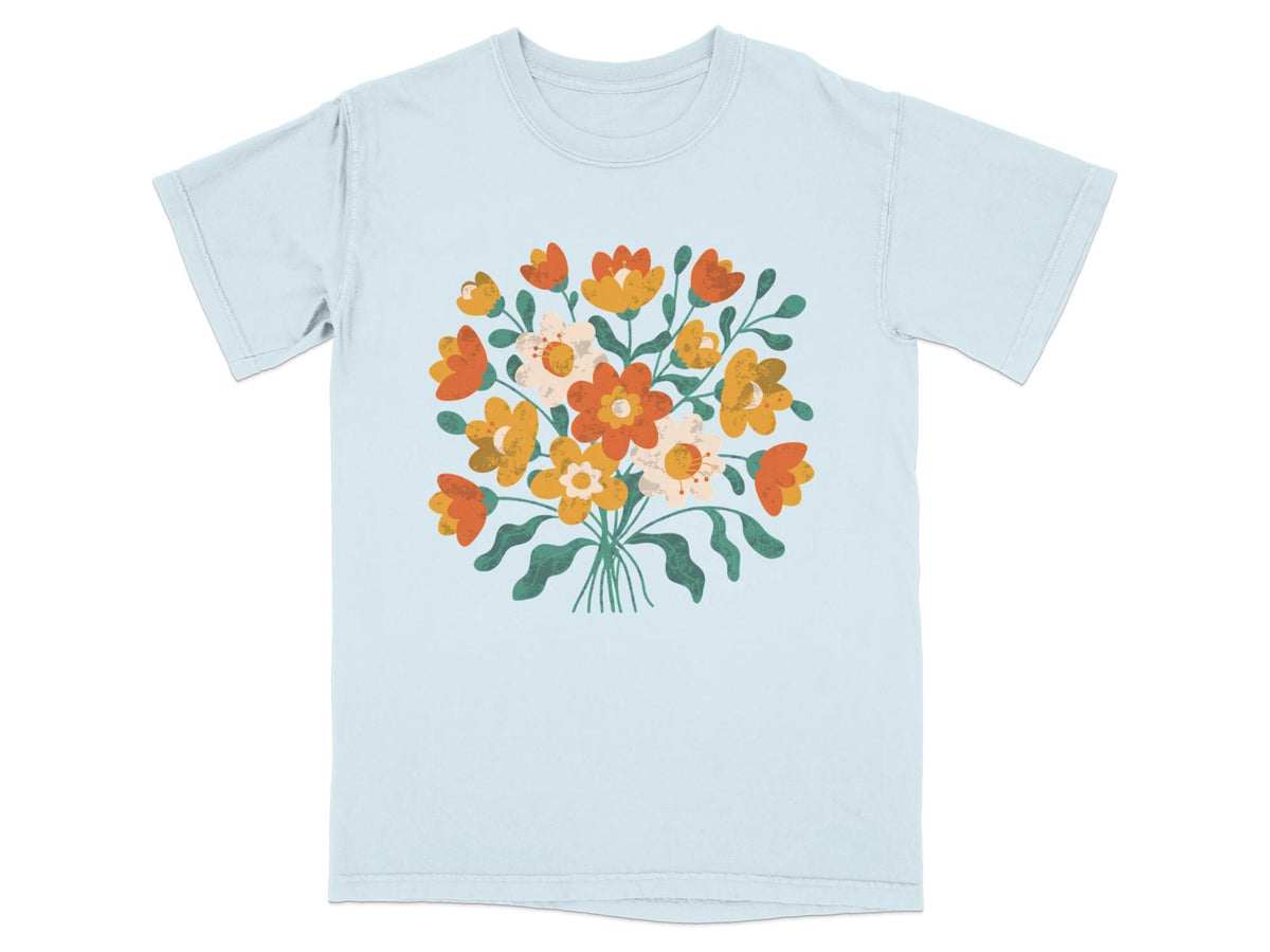 Light blue t-shirt with a bouquet of orange, yellow, and white flowers.