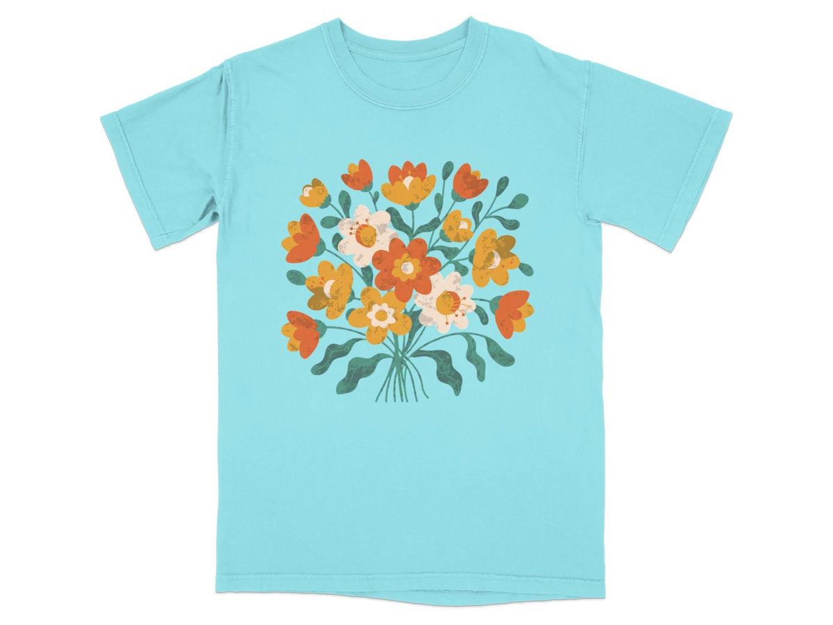 Light blue t-shirt with a colorful bouquet of stylized orange, yellow, and white flowers.
