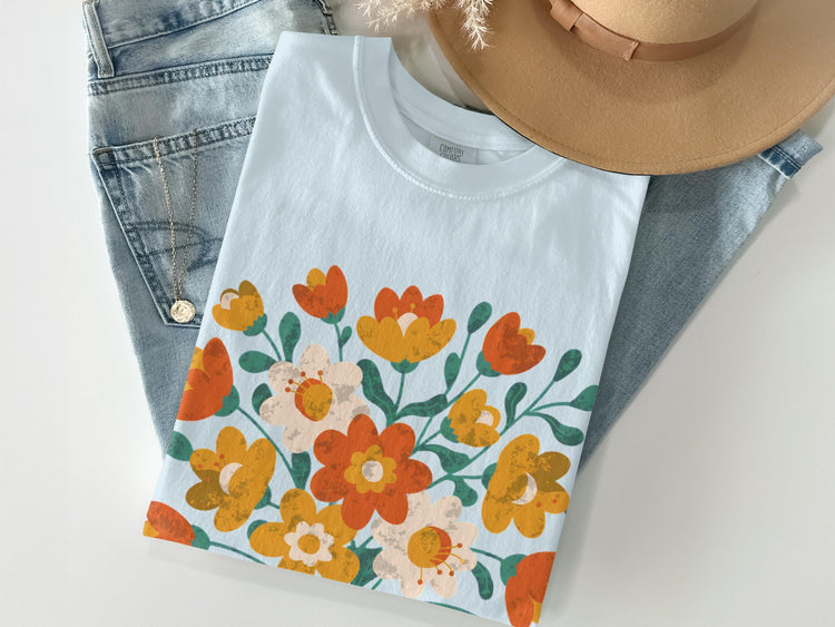 Light blue t-shirt with a retro floral print and denim accents.