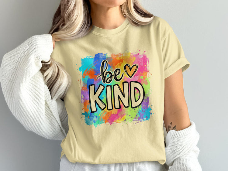Yellow t-shirt with "be KIND" text and colorful paint splatters.