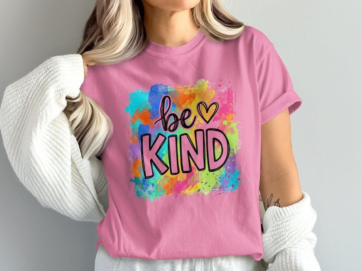 Pink t-shirt with watercolor splatter and "be KIND" text.