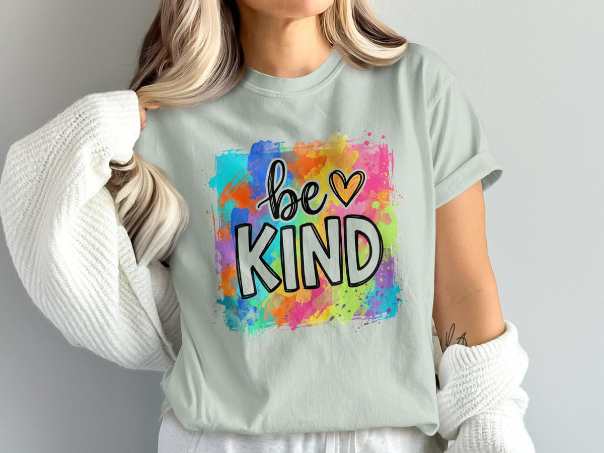 Light blue t-shirt with "be KIND" text and colorful watercolor splash graphic.