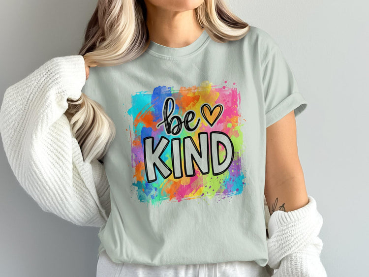 Light blue t-shirt with "be KIND" text and colorful watercolor splash graphic.