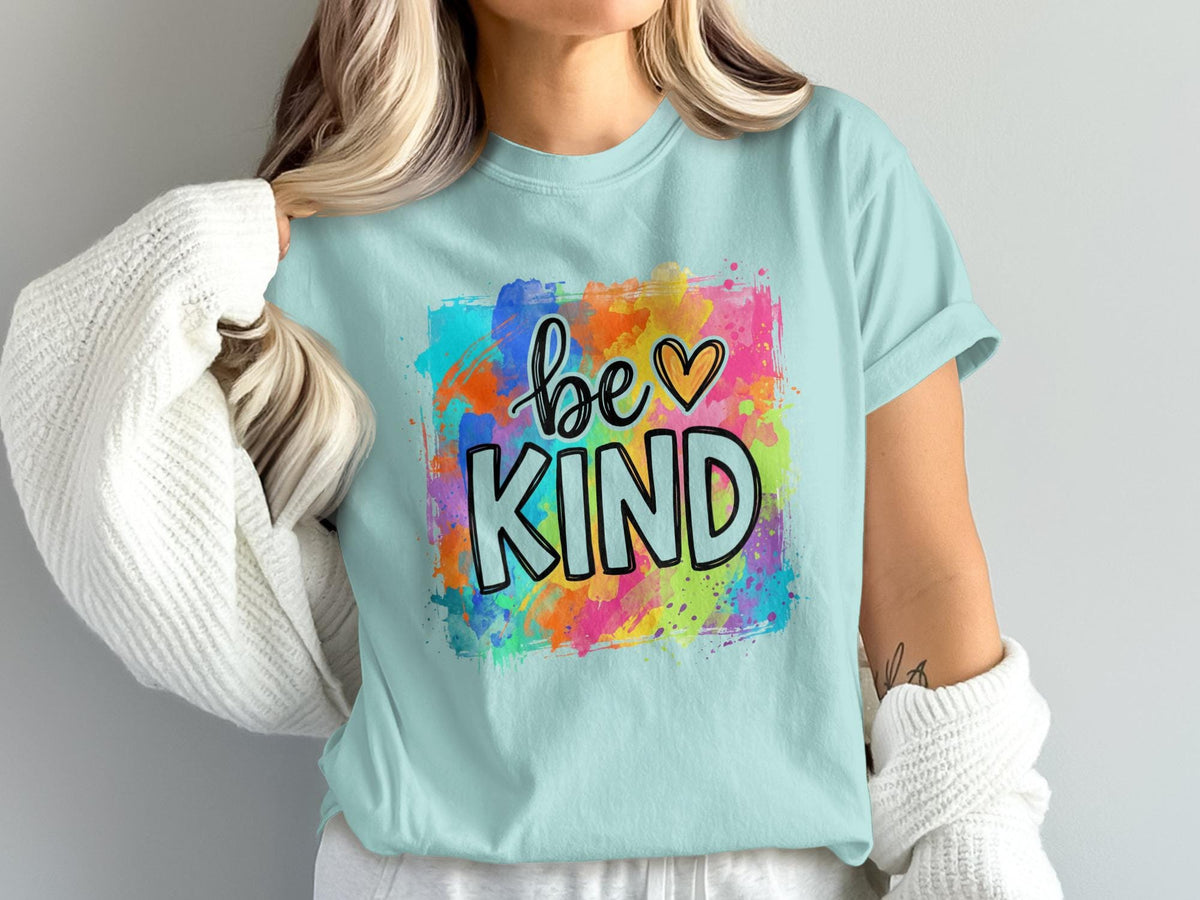Light blue t-shirt with "be ♡ KIND" text in colorful watercolor splash design.