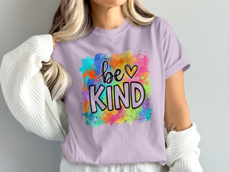 Lavender t-shirt with "be KIND" text and colorful watercolor splatter design.