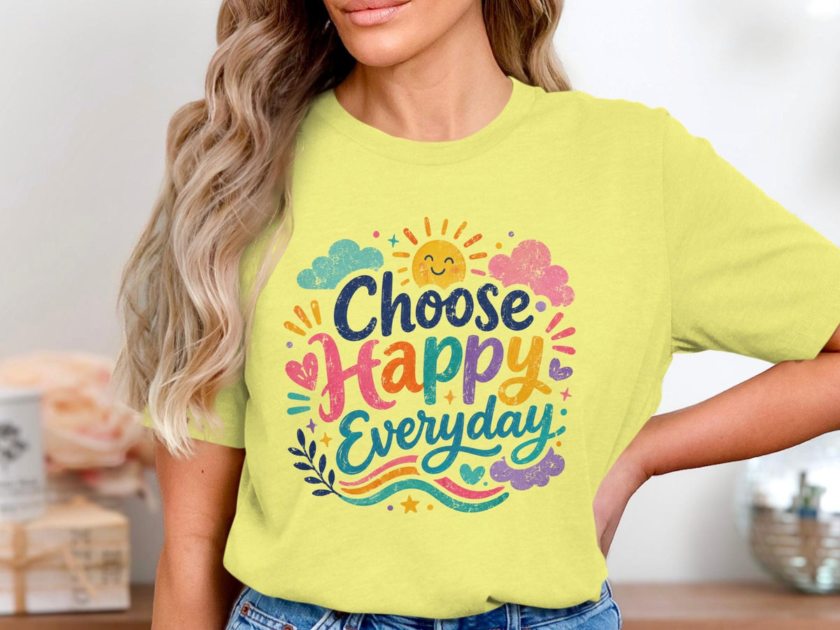 Yellow t-shirt with "Choose Happy Everyday" text and sun, clouds, and hearts design.