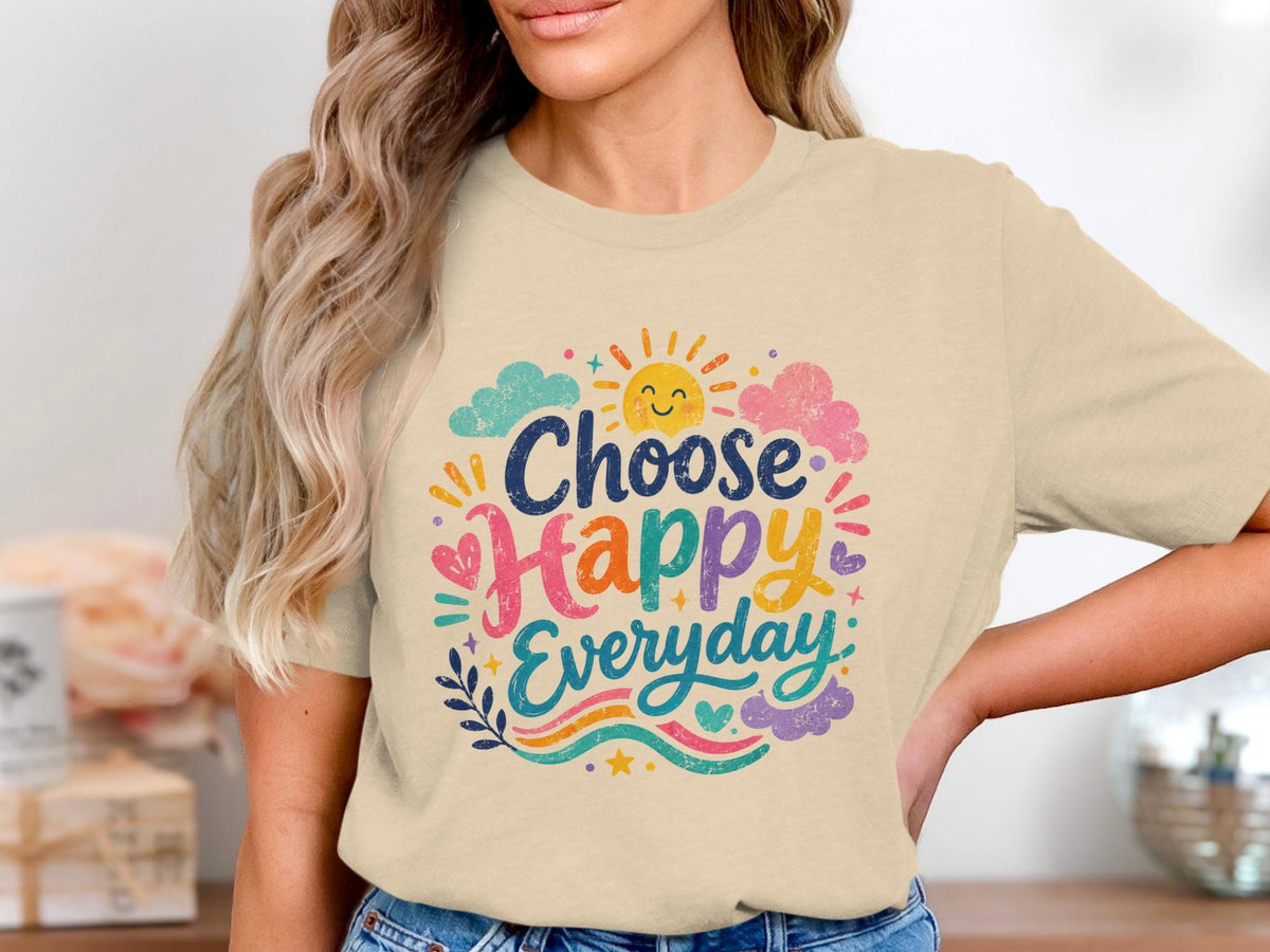 Cream t-shirt with "Choose Happy Everyday" in colorful whimsical font with sun and clouds.